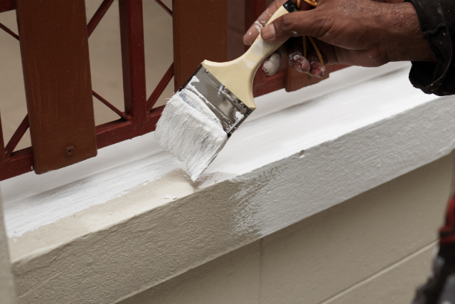 House painter painting exterior wall
