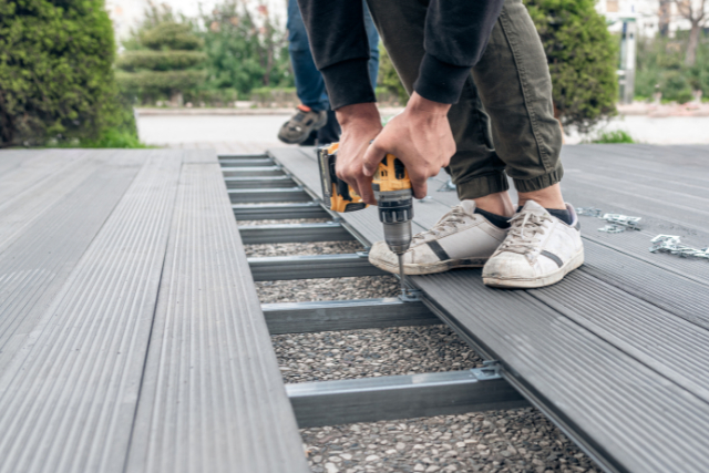 Worker assembling composite deck