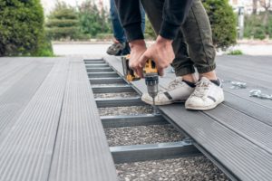 Worker assembling composite deck